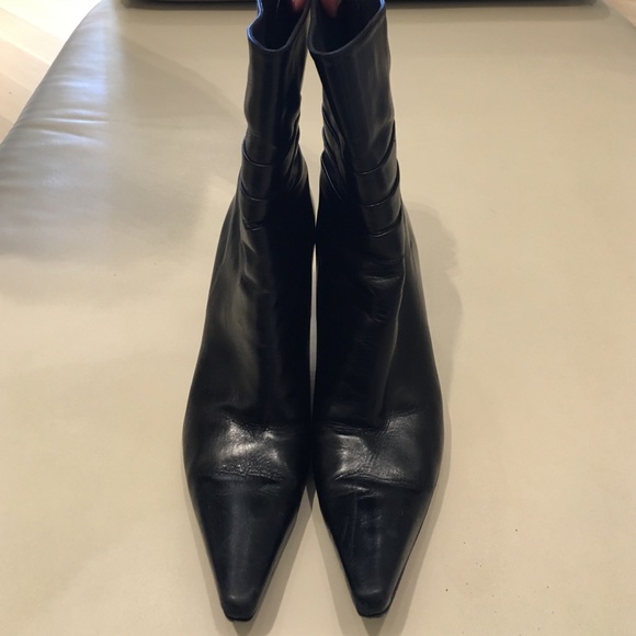 Stuart Weitzman black leather pointy toe boots.