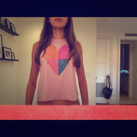 A light pink muscle tank with a heart on it
