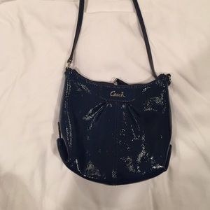 navy blue glossy coach purse