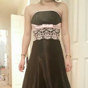 Black strapless dress with pink bow and sequin det