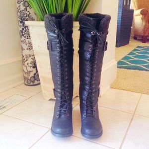 Tall black boots. Faux fur trim at top