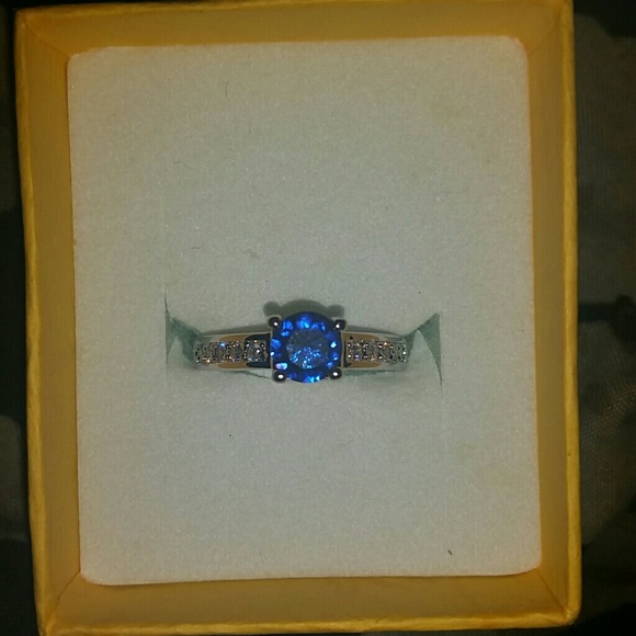 Silver ring with a dark sapphire stone