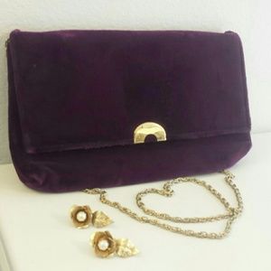 Velvety violet cross body purse with gold chain.