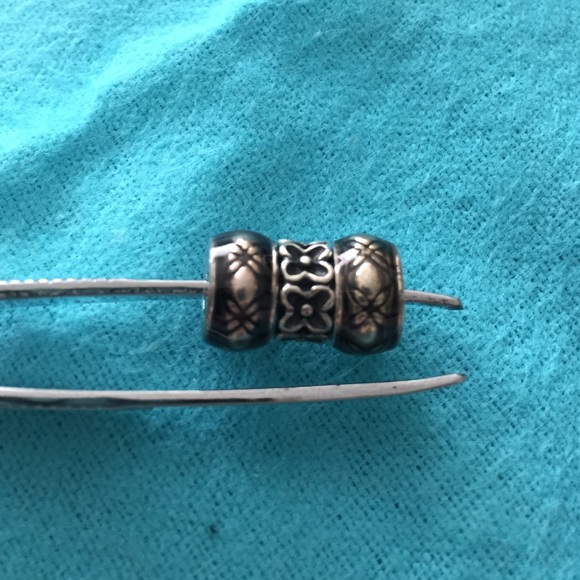 Set of three pandora charms.