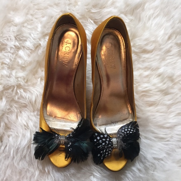 Yellow gold colored silk peep toe heels.