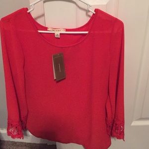 Francesca's orange/red blouse