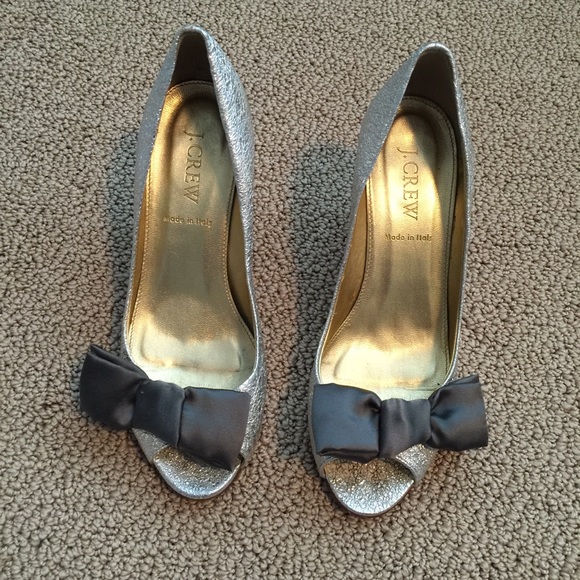 Metallic silver leather peep toes with silk bow.