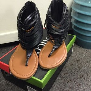 Black fringed "Westwood" sandal.