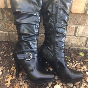 Slouched, cuffed and strappy knee high black boots