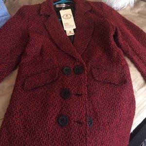 À small red/black peacoat.