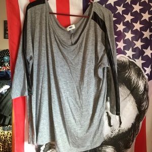 Grey with black leather on the sleeves