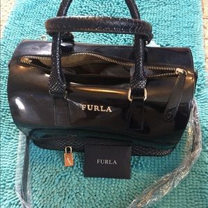 Black Furla handbag with texture hands.
