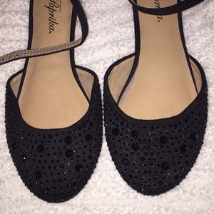 Black flats with a strap.