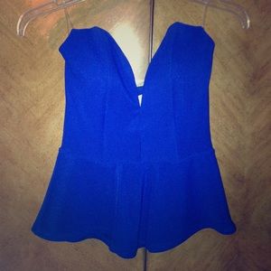 Blue strapless top, deep V cut, flare out bottom.
