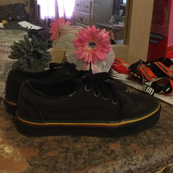 Black vans with rasta color stripes