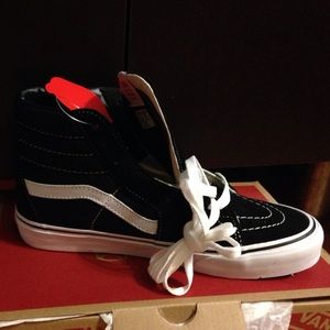 Black and white high top vans