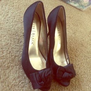 Worn once. Black heels with bow detail.