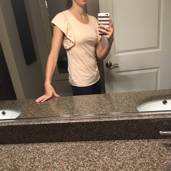 Peach sleeveless top with arm ruffle