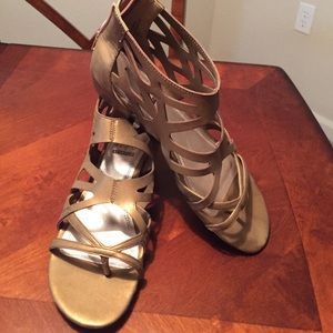 Slightly wedged gold strappy sandals, thong style