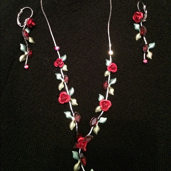 Matching set of silver rose earrings and necklace.