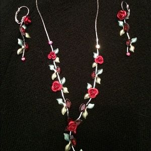 Matching set of silver rose earrings and necklace.