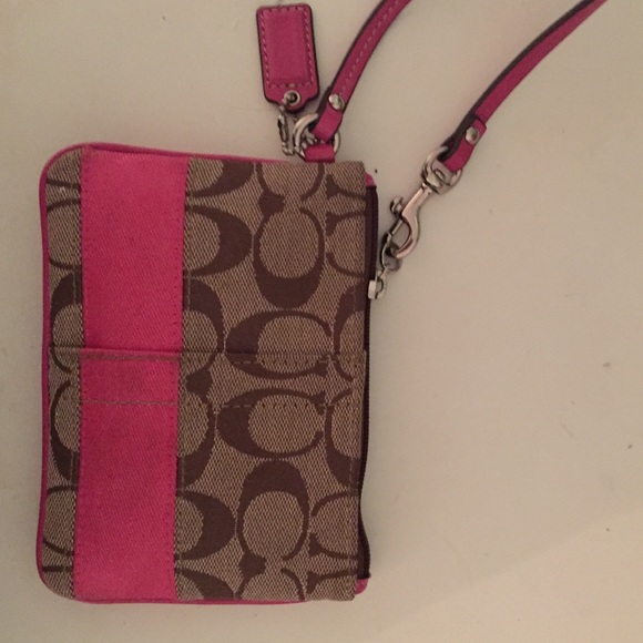 Coach wristlet with pink striping.