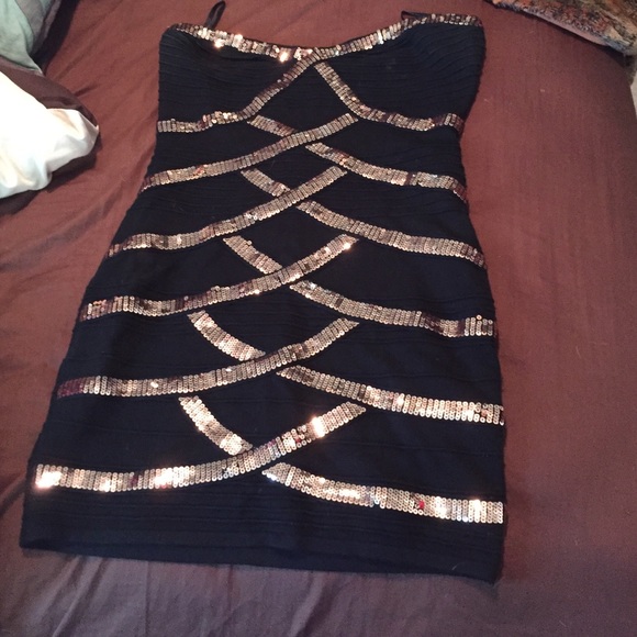 HOLDING Little black dress w/ bronze criss crosses