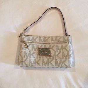 White and tan Michael Kors wristlet.