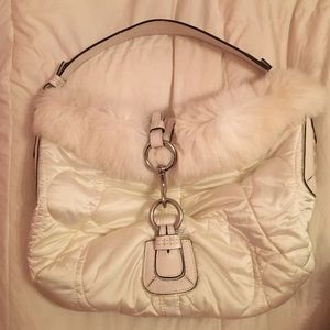 White furry coach bag.