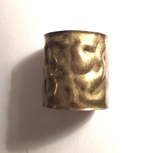 Gold colored metal cuff bracelet