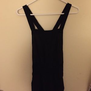 Black overall style jumper and green jacket