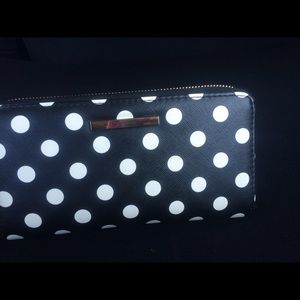 A non labeled wallet  with white poker dots