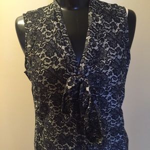 Black and white button down sleeveless blouse.
