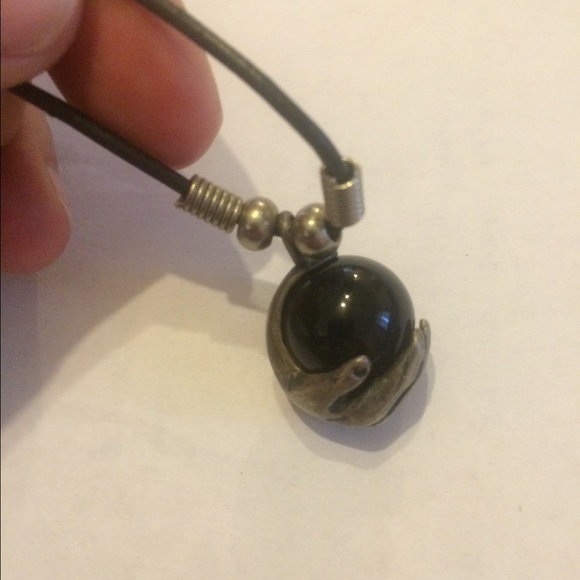 Hand crafted real silver hand holding round stone