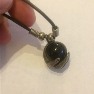 Hand crafted real silver hand holding round stone