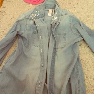 A blue jean shirt with diamonds on top