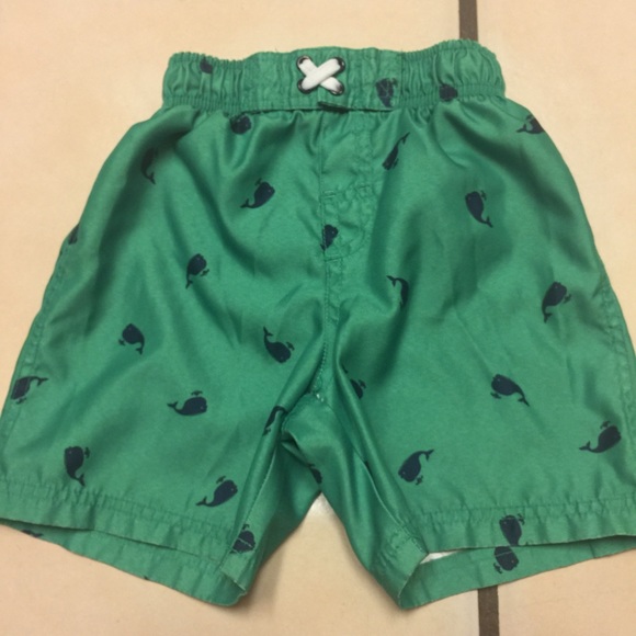 Green swim shorts with blue whales