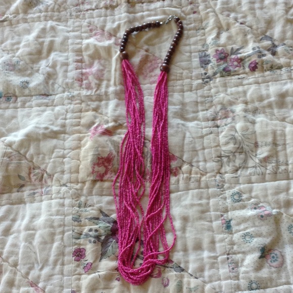 Long multi-strand pink bead necklace.