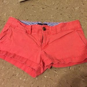 Coral colored shorts.
