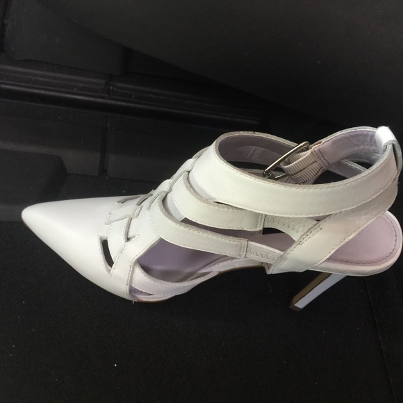 White enclosed pumps with buckles on side