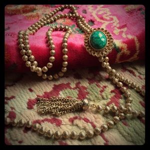 Bolo tie necklace with green-colored stone