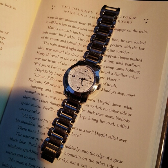 Micheal Kors silver watch with white background