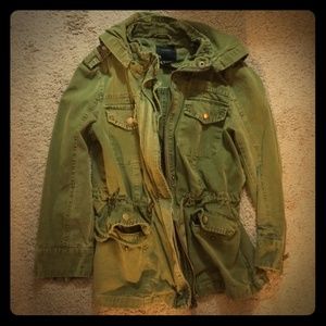 Hooded green zipper jacket.