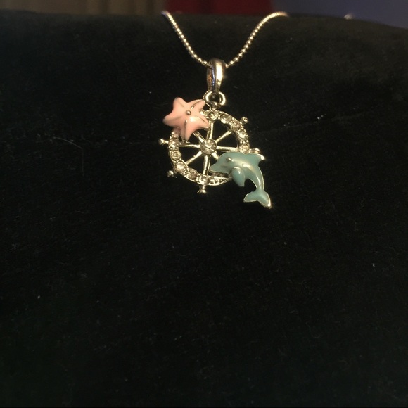 Dolphin and starfish necklace on captain wheel