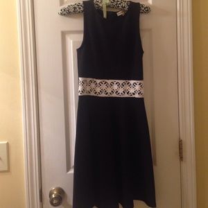 A black dress w/ white floral strap