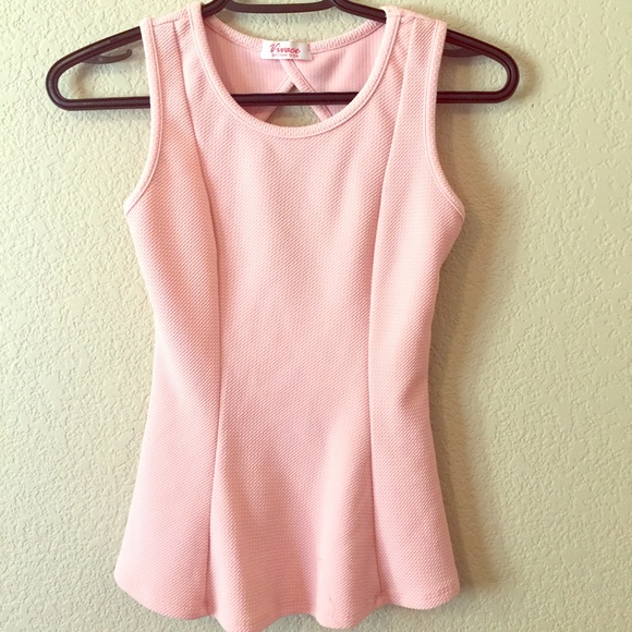 Great pink sleeveless top with flare at bottom.