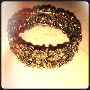 Gold bangle bracelet with flower design