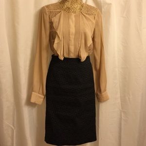 Sheer, lacy, nude blouse.