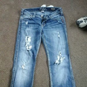 Distressed silver jeans