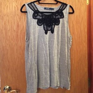 Grey tank with cutout design at neck.